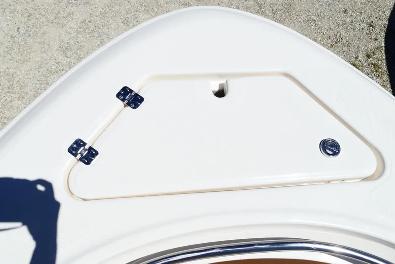 Slide: The Image of Bow storage compartment on 2026 Pioneer 222 Islander boat, featuring secure hinges and latch. - 26