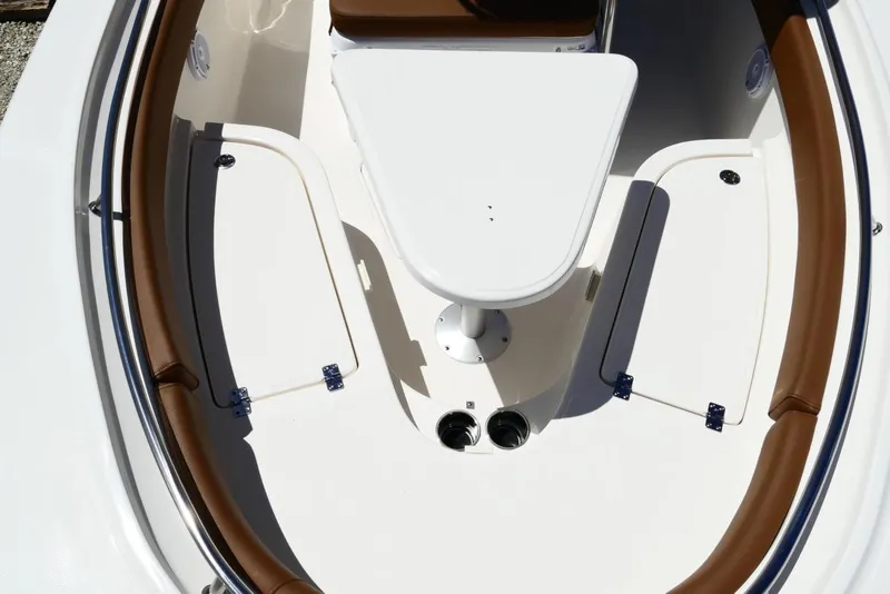 Slide: The Image of 2026 Pioneer 222 Islander boat interior with brown seating and white table. - 28