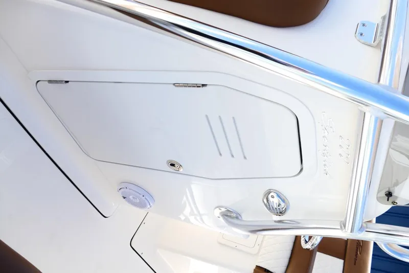 Slide: The Image of 2026 Pioneer 222 Islander boat interior with storage compartment and speaker. - 33