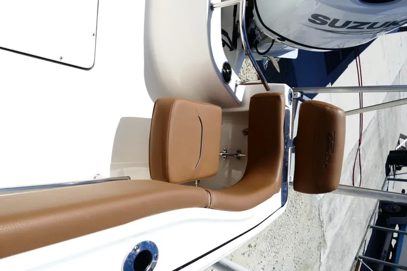 Slide: The Image of 2026 Pioneer 222 Islander boat interior with brown seating and Suzuki engine. - 37