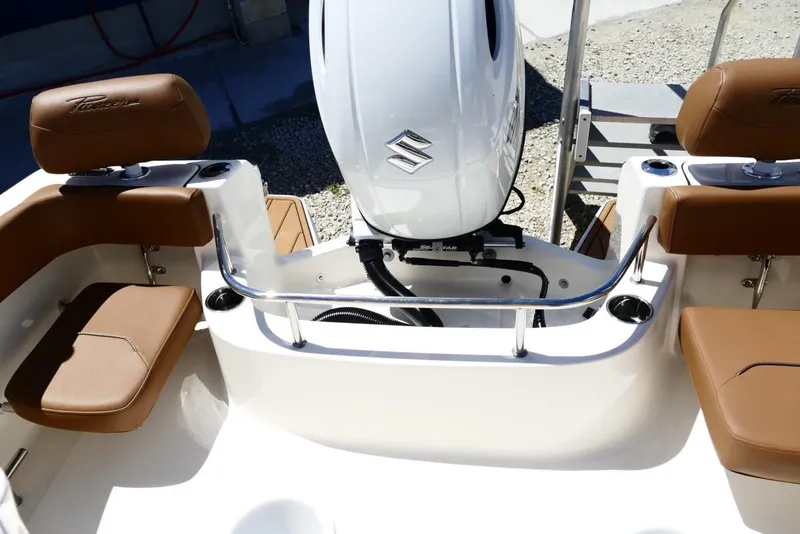 Slide: The Image of 2026 Pioneer 222 Islander boat interior with Suzuki outboard motor and tan seating. - 38