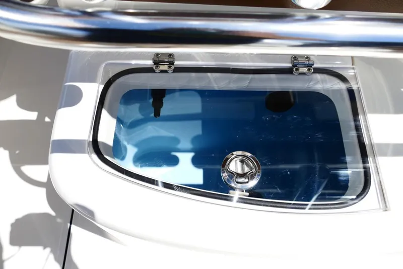 Slide: The Image of Livewell on 2026 Pioneer 222 Islander boat, featuring a clear lid and stainless steel hardware. - 39