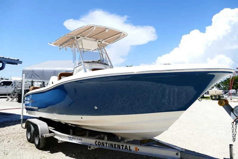 Slide: The Image of 2026 Pioneer 222 Islander boat on trailer under clear blue sky. - 4