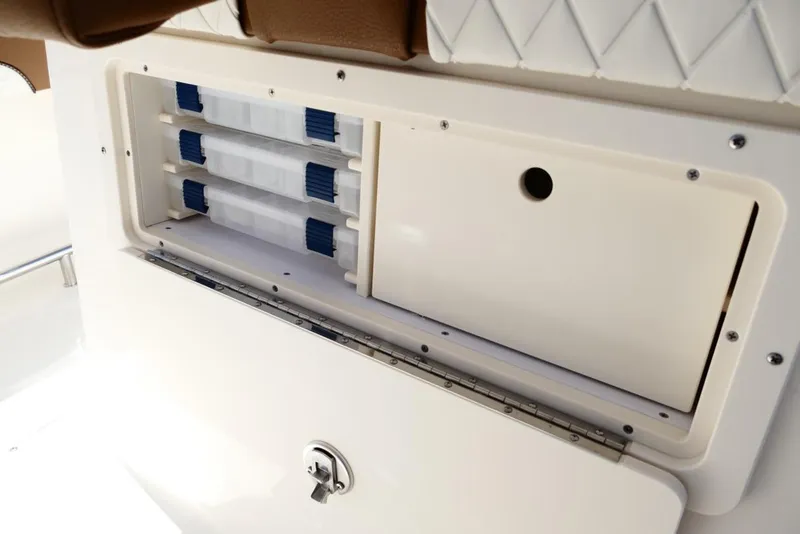 Slide: The Image of Storage compartment on 2026 Pioneer 222 Islander boat, featuring secure latch and organized interior. - 41