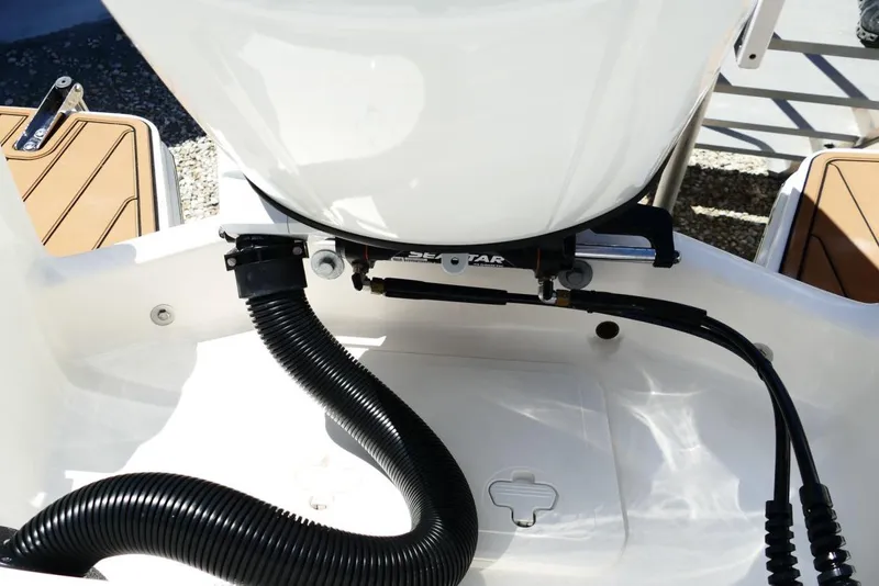 Slide: The Image of 2026 Pioneer 222 Islander boat engine compartment with hoses and fittings. - 45