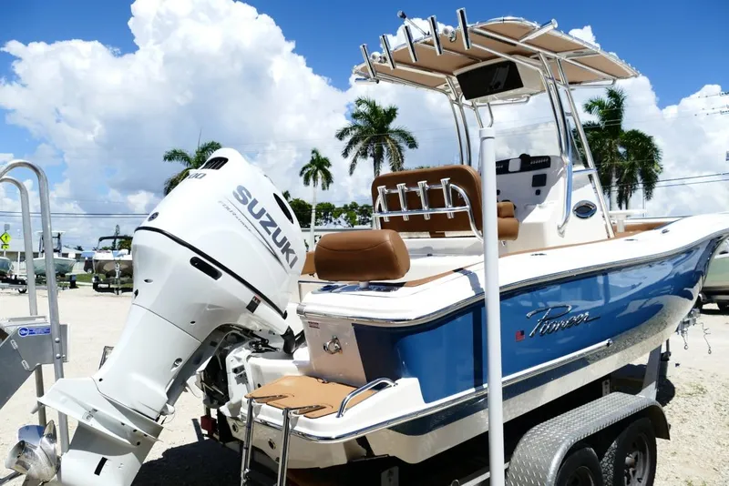 Slide: The Image of 2026 Pioneer 222 Islander boat with Suzuki engine, parked on trailer under sunny skies. - 5