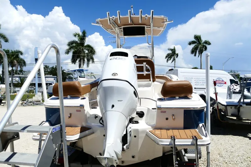 Slide: The Image of 2026 Pioneer 222 Islander boat with outboard motor, displayed outdoors under a sunny sky. - 6