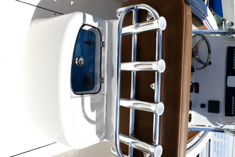 Slide: The Image of 2026 Pioneer 222 Islander boat interior with rod holders and control panel. - 8