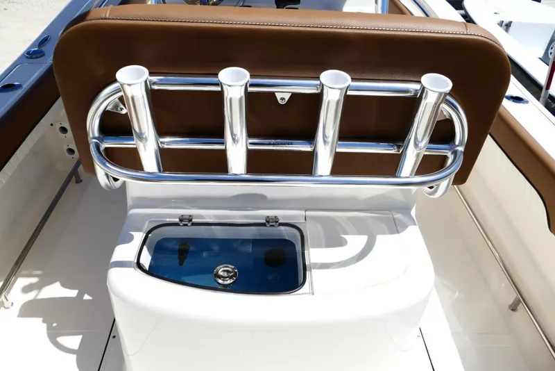 Slide: The Image of 2026 Pioneer 222 Islander boat with rod holders and livewell, featuring brown seating. - 9
