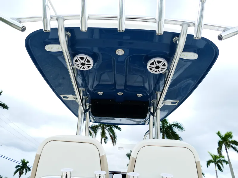 Slide: The Image of 2026 Bulls Bay 255CC boat T-top with speakers and rod holders, viewed from below. - 12