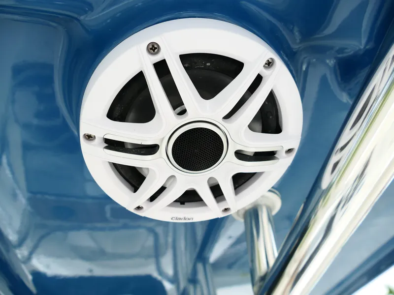 Slide: The Image of White marine speaker on Bulls Bay 255CC boat, 2026 model, with blue background. - 13