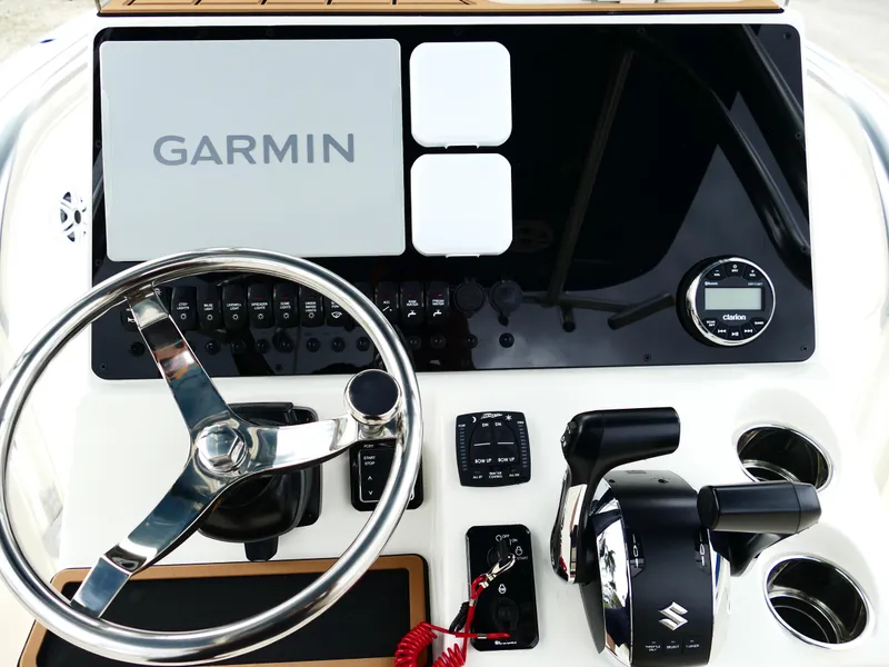 Slide: The Image of 2026 Bulls Bay 255CC boat dashboard with Garmin display and controls. - 14