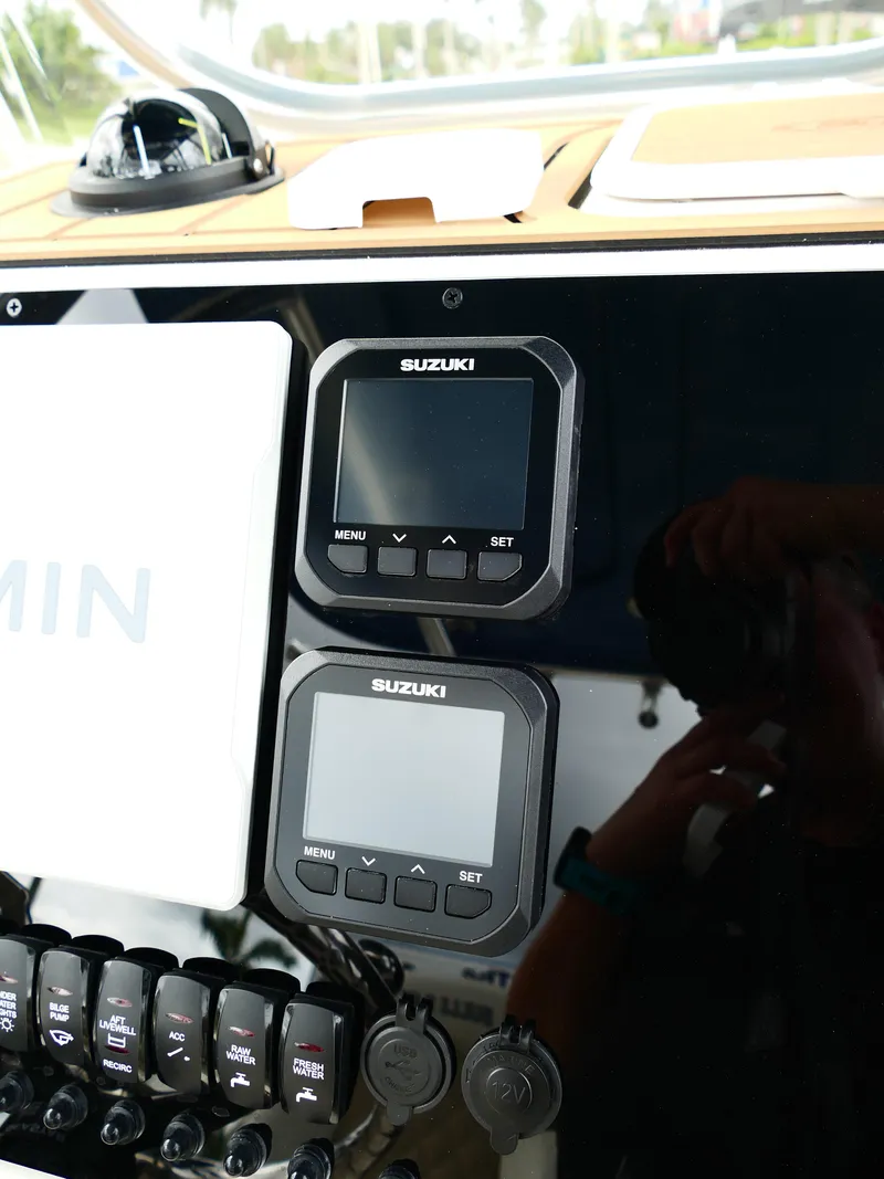 Slide: The Image of Dashboard of 2026 Bulls Bay 255CC boat with Suzuki displays and Garmin equipment. - 17