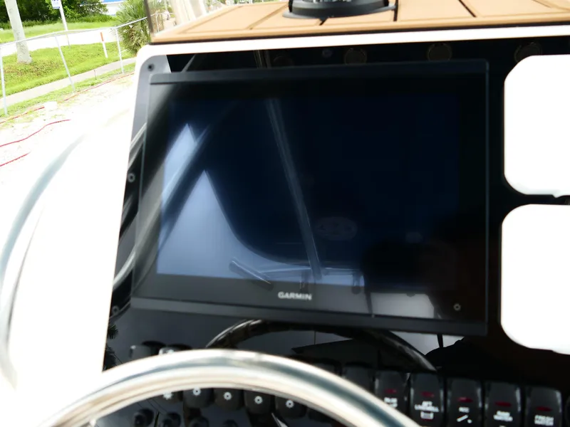 Slide: The Image of 2026 Bulls Bay 255CC boat dashboard with Garmin display and steering wheel. - 19