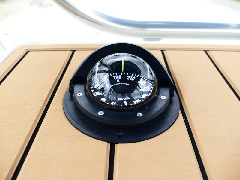 Slide: The Image of Compass on Bulls Bay 255CC boat dashboard, 2026 model, with wooden paneling. - 22