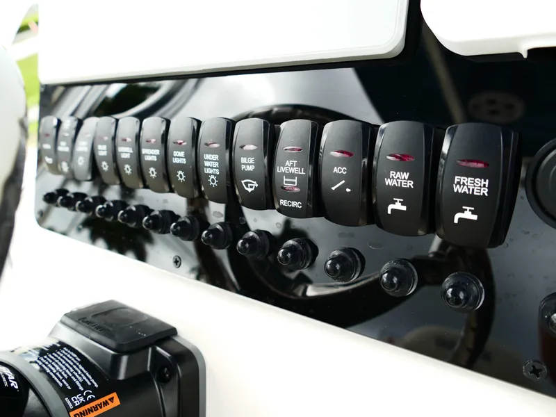 Slide: The Image of Control panel of 2026 Bulls Bay 255CC boat with various switches and labels. - 23