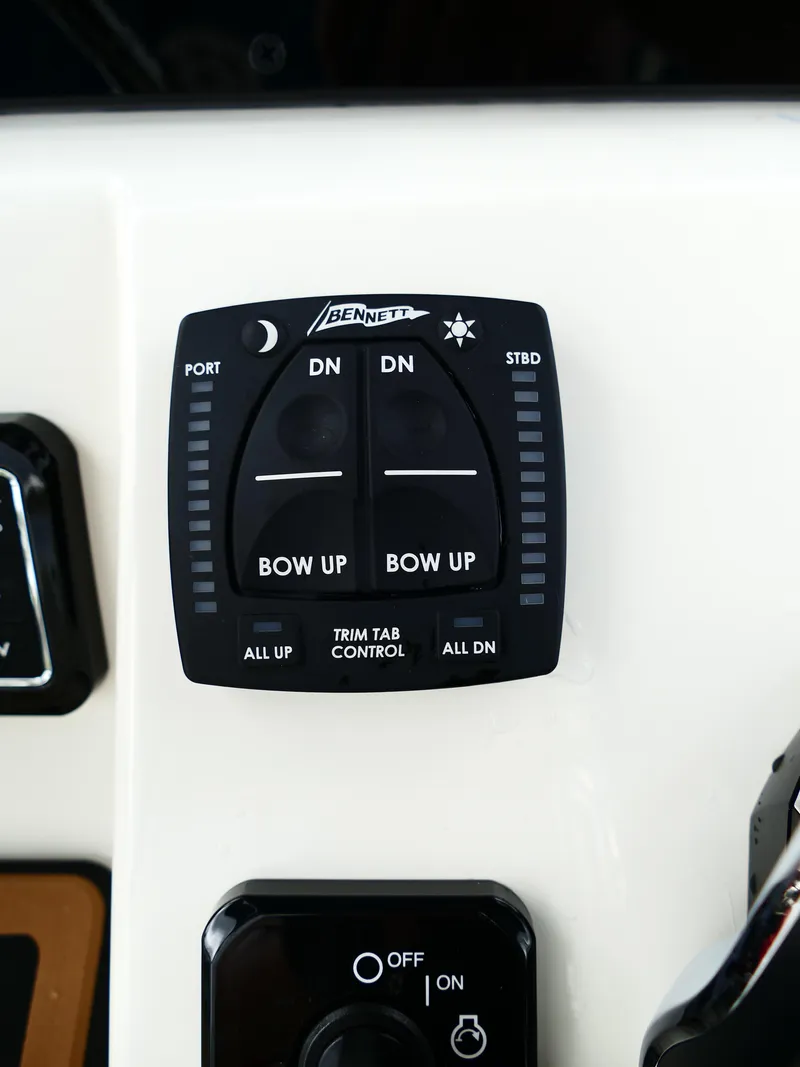 Slide: The Image of Bulls Bay 255CC 2026 trim tab control panel with Bennett switches. - 24