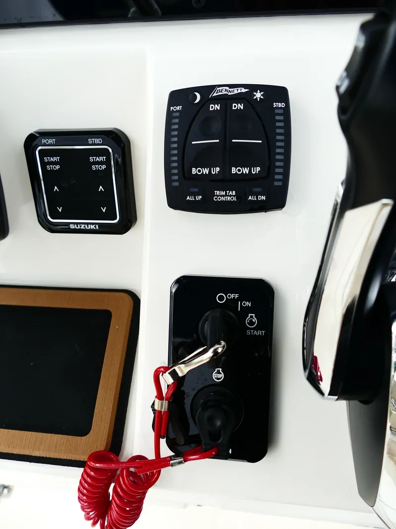 Slide: The Image of Control panel of a 2026 Bulls Bay 255CC boat with trim tab and ignition switches. - 25