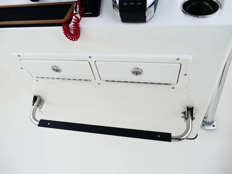Slide: The Image of Bulls Bay 255CC 2026 boat console with storage compartments and footrest. - 27