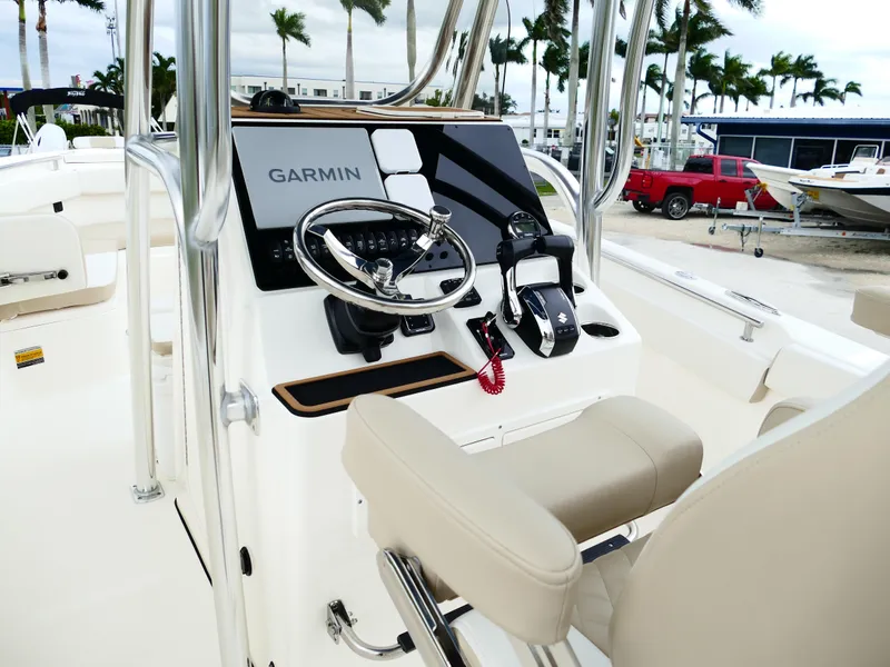 Slide: The Image of 2026 Bulls Bay 255CC boat console with Garmin navigation, steering wheel, and controls. - 31