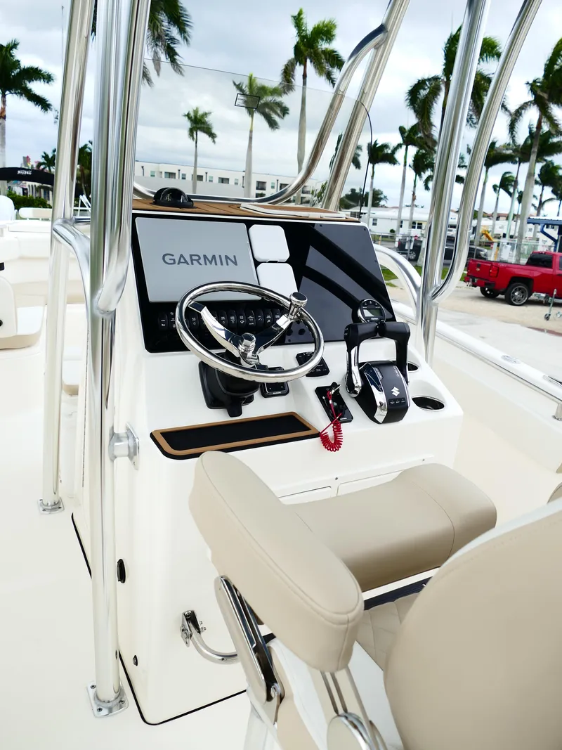 Slide: The Image of 2026 Bulls Bay 255CC boat console with Garmin navigation, steering wheel, and controls. - 32