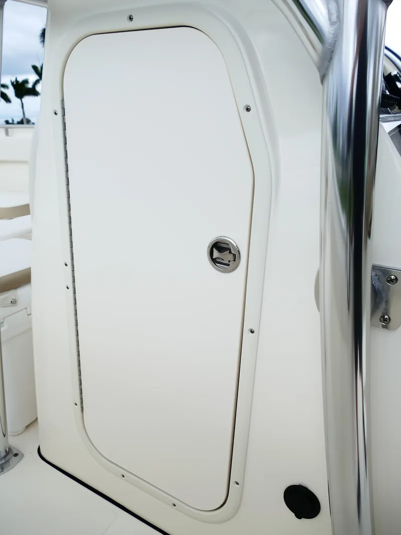 Slide: The Image of 2026 Bulls Bay 255CC boat cabin door with sleek design and chrome handle. - 33
