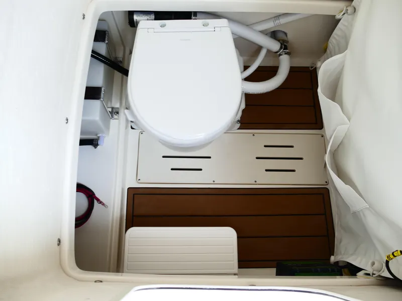 Slide: The Image of 2026 Bulls Bay 255CC boat interior with toilet and wooden flooring. - 36