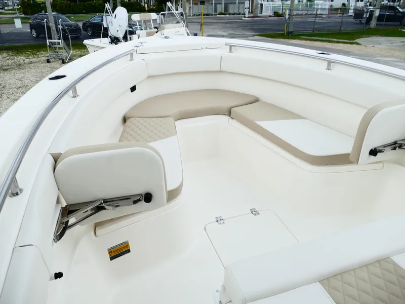 Slide: The Image of 2026 Bulls Bay 255CC boat interior with cushioned seating and stainless steel railings. - 37