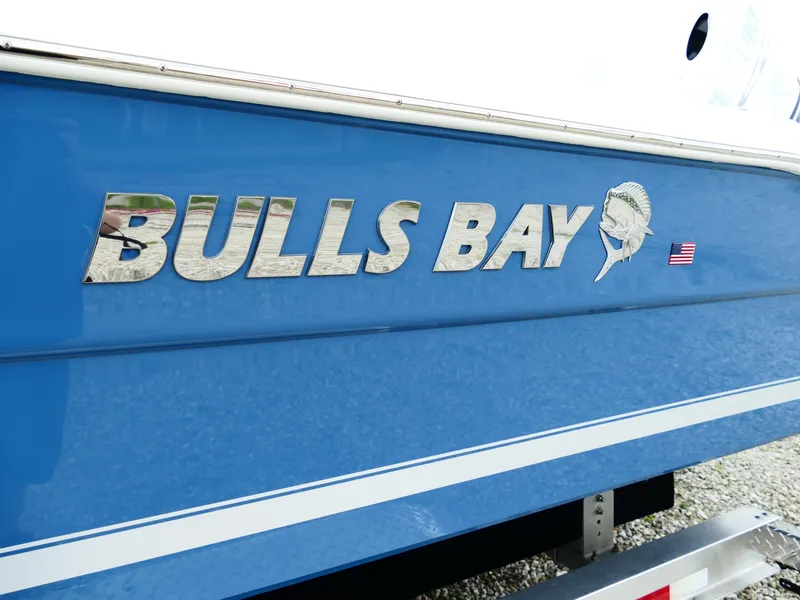 Slide: The Image of 2026 Bulls Bay 255CC boat with blue hull and chrome logo. - 4