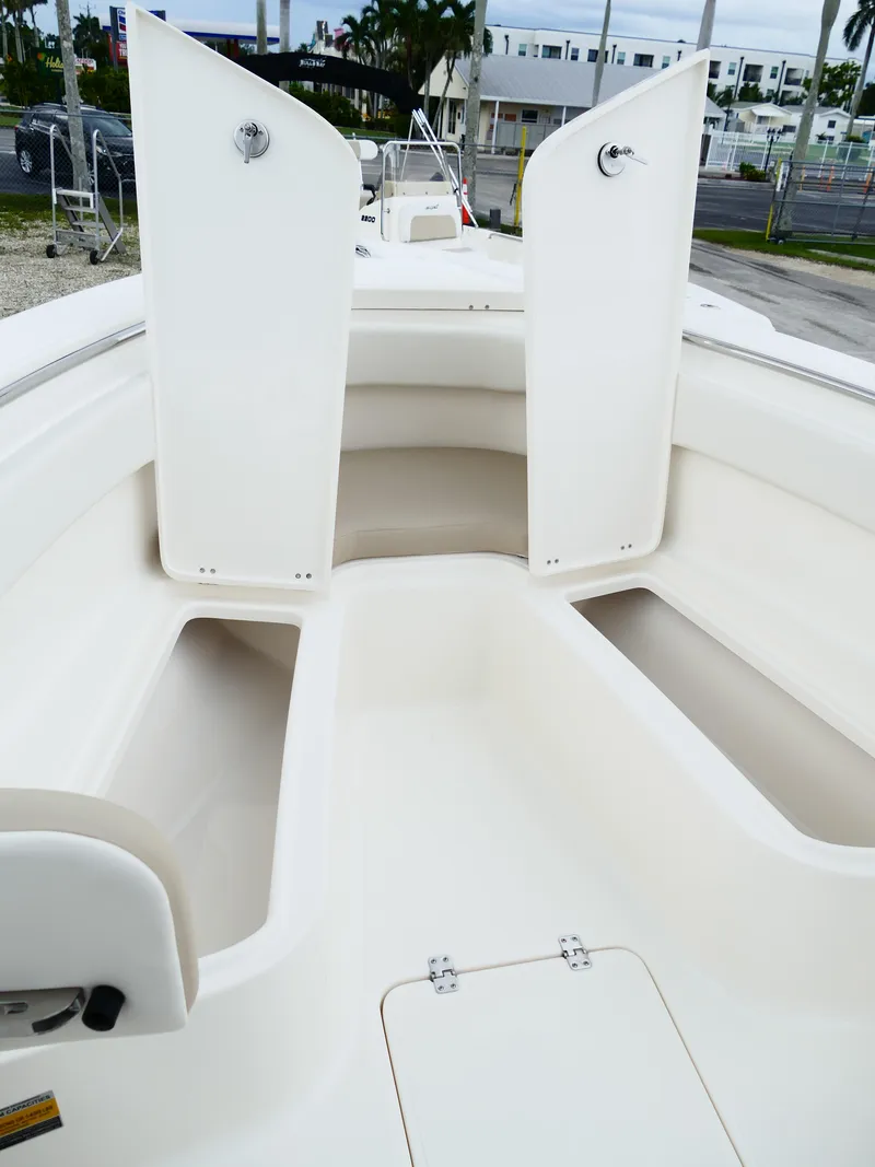 Slide: The Image of 2026 Bulls Bay 255CC boat interior with open storage compartments and seating area. - 40