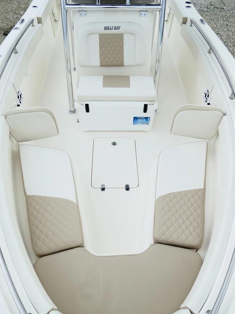 Slide: The Image of 2026 Bulls Bay 255CC boat interior with cushioned seating and storage compartments. - 44