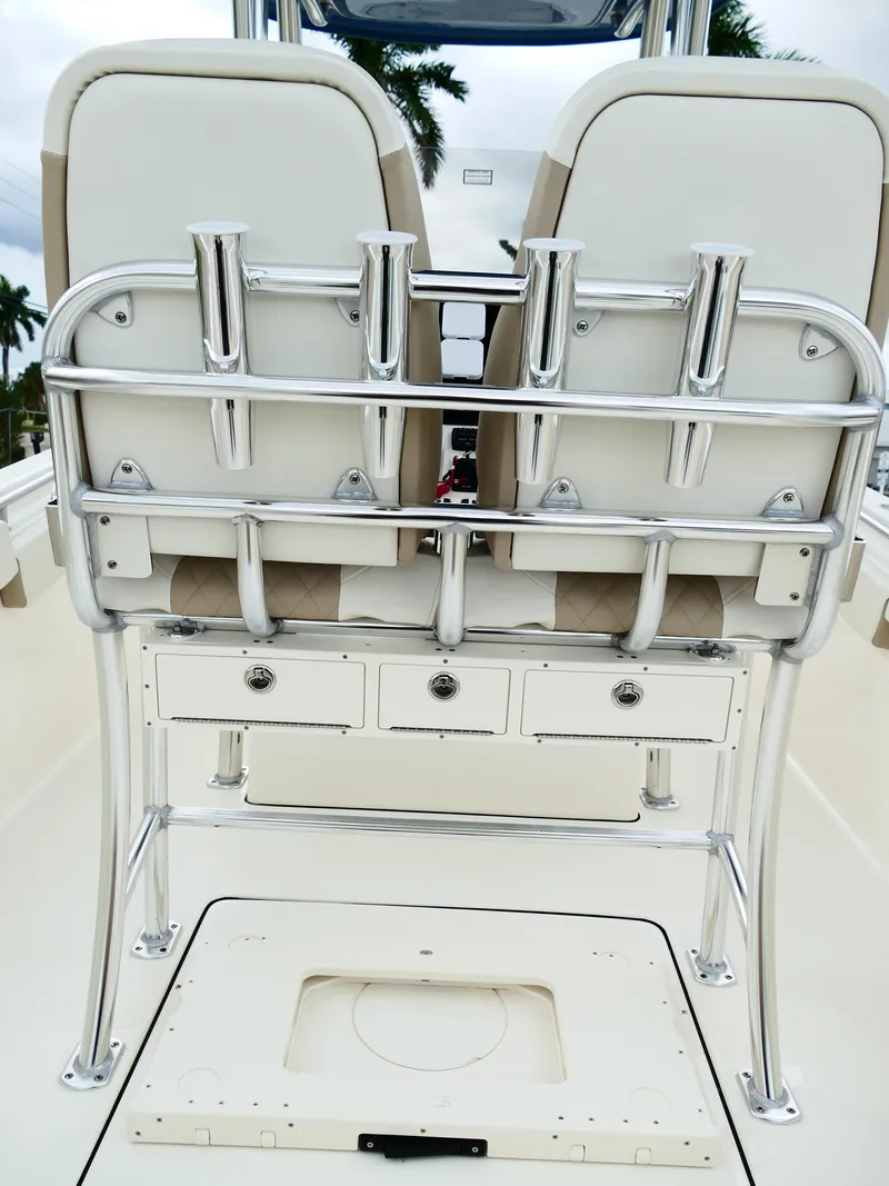 Slide: The Image of 2026 Bulls Bay 255CC boat interior with rod holders and storage drawers. - 7