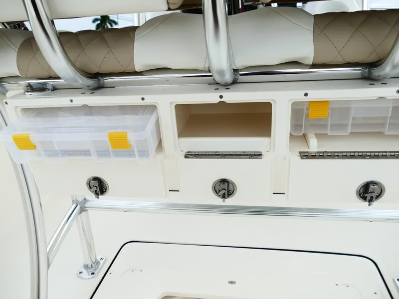 Slide: The Image of Bulls Bay 255CC 2026 boat storage compartments with tackle boxes and cushioned seating. - 9