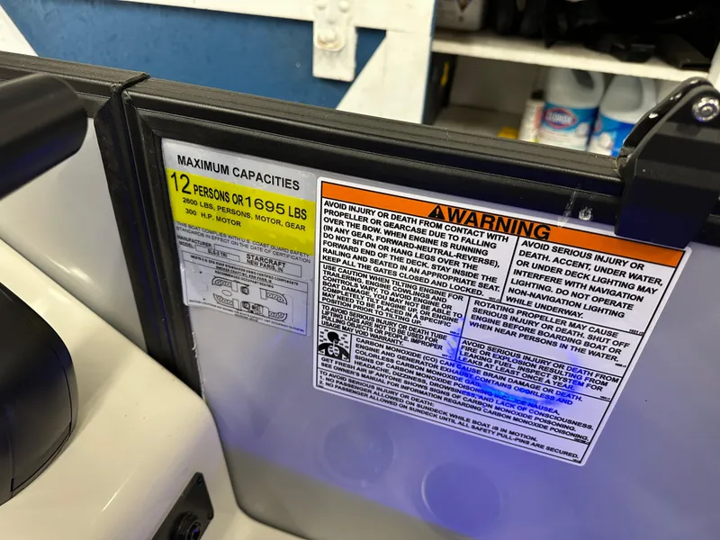 Slide: The Image of Safety warning labels on 2022 Starcraft SLS 3 boat, indicating maximum capacity and safety instructions. - 15