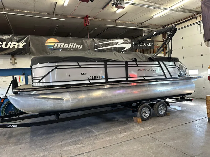 Slide: The Image of 2022 Starcraft SLS 3 pontoon boat on trailer in indoor storage. - 20