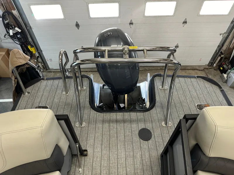 Slide: The Image of 2022 Starcraft SLS 3 boat interior with motor and seating, in a garage setting. - 5
