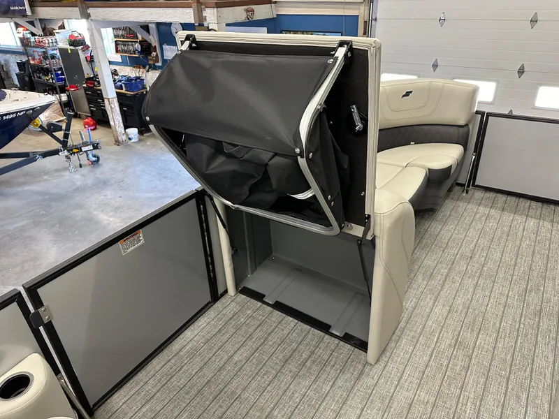 Slide: The Image of 2022 Starcraft SLS 3 boat interior with storage compartment and seating. - 9