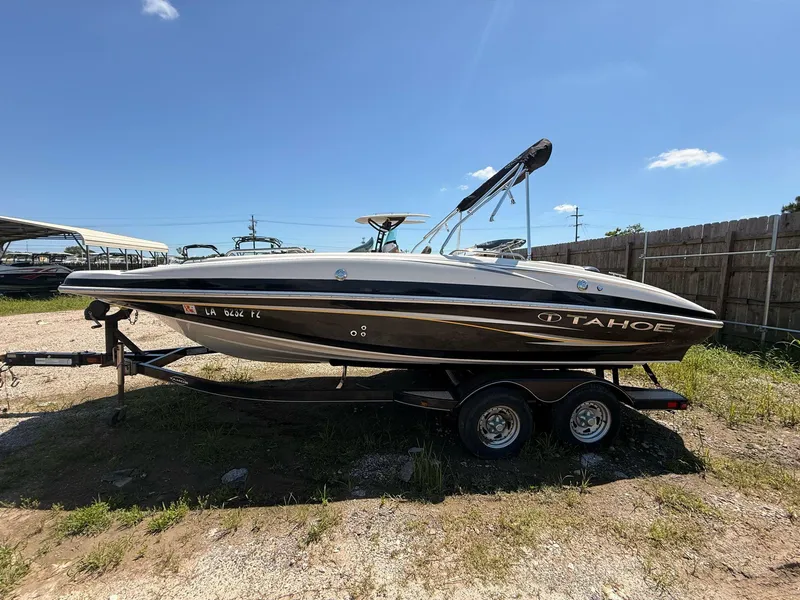 Slide: The Image of 2012 Tahoe 195 boat on trailer under clear blue sky. - 3