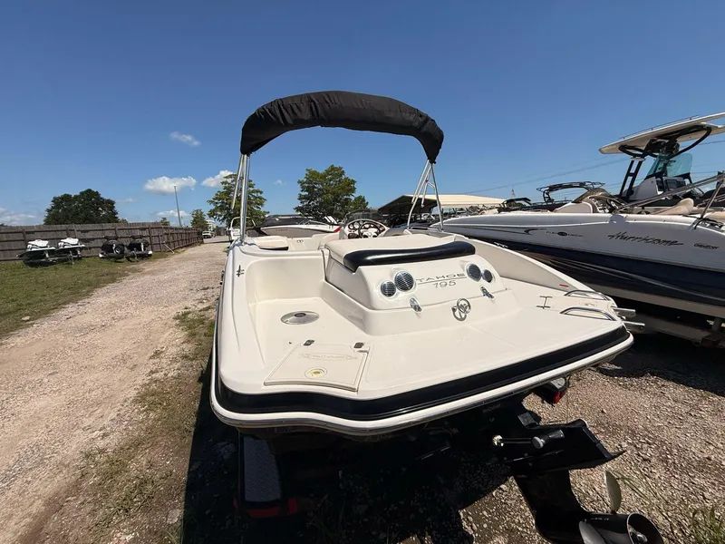 Slide: The Image of 2012 Tahoe 195 boat with canopy, parked outdoors on a sunny day. - 4