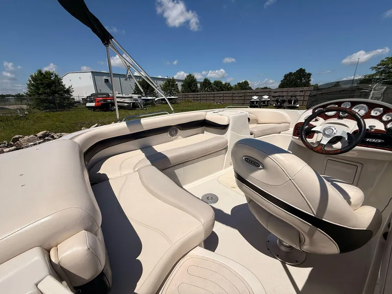 Slide: The Image of Interior of a 2012 Tahoe 195 boat with steering wheel and seating under blue sky. - 6