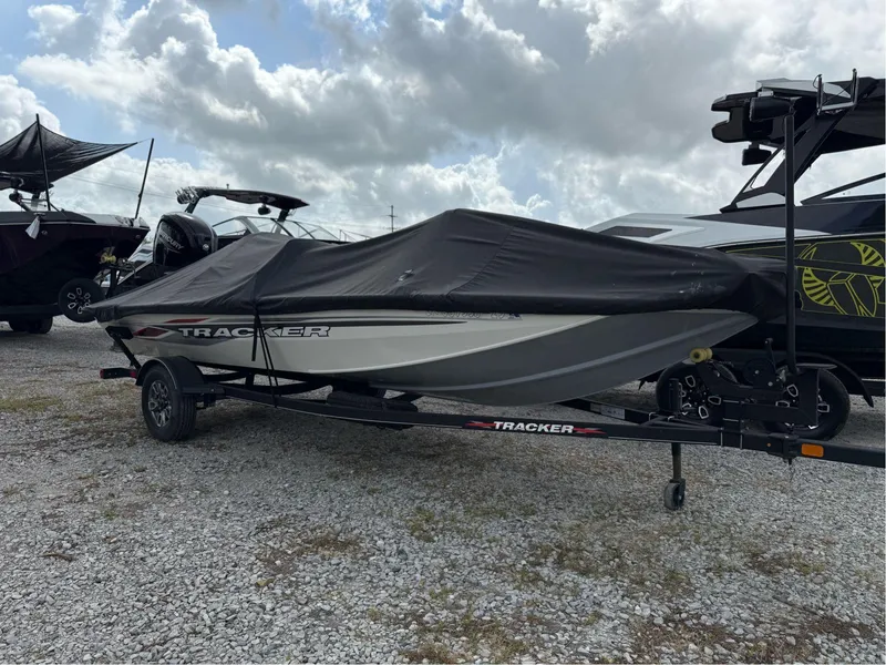 Slide: The Image of 2023 Tracker Pro Team 175 TXW boat covered on trailer, parked outdoors. - 3