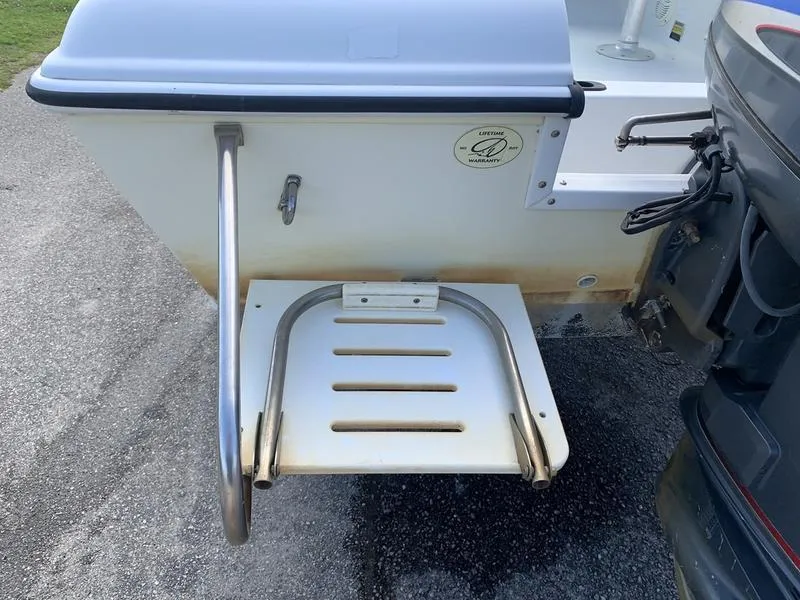 Slide: The Image of 2005 Sailfish 198 DC boat swim platform with ladder and outboard motor. - 10