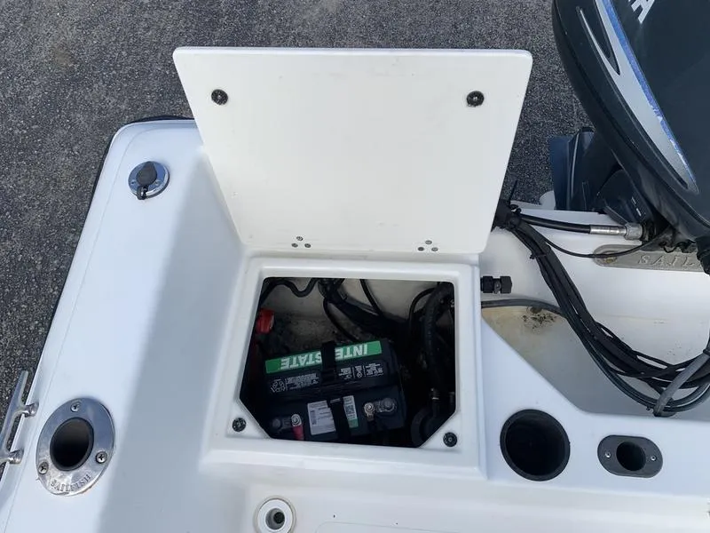 Slide: The Image of Battery compartment of a 2005 Sailfish 198 DC boat, showing wiring and engine connections. - 11