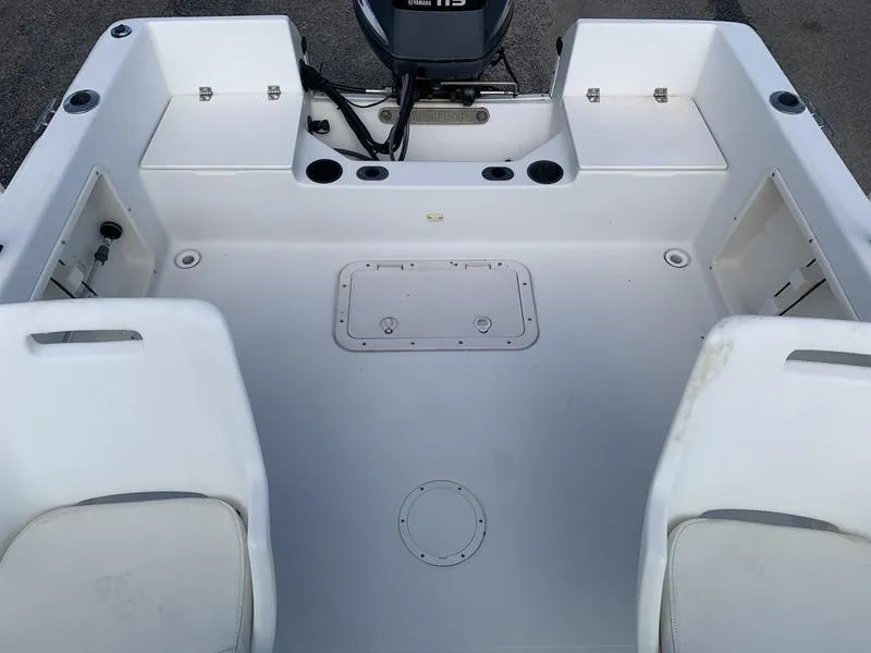 Slide: The Image of 2005 Sailfish 198 DC boat interior with seating and storage compartments. - 13