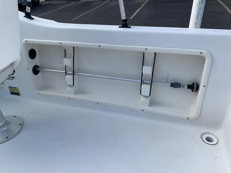 Slide: The Image of 2005 Sailfish 198 DC boat interior storage compartment with rod holders. - 15