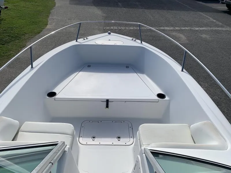 Slide: The Image of 2005 Sailfish 198 DC boat interior, featuring spacious seating and storage compartments. - 21