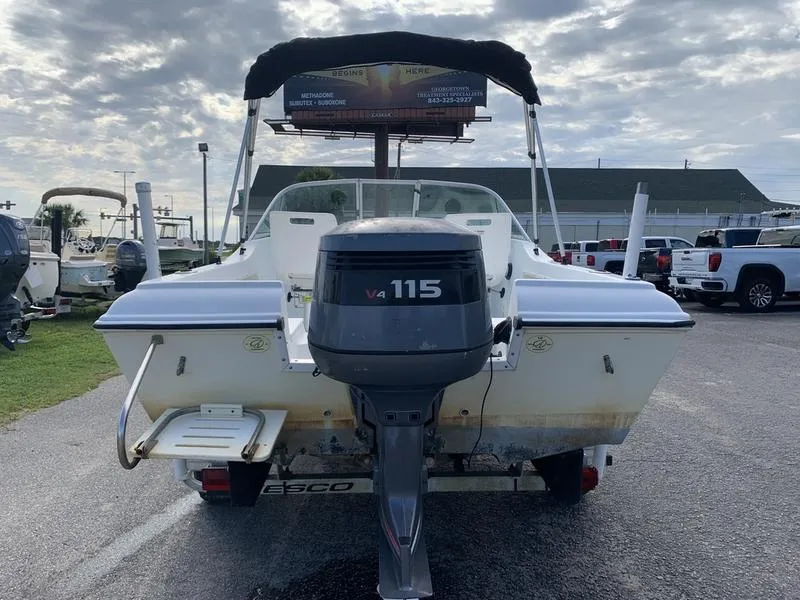 Slide: The Image of 2005 Sailfish 198 DC boat with Yamaha V4 115 outboard motor, parked outdoors. - 3