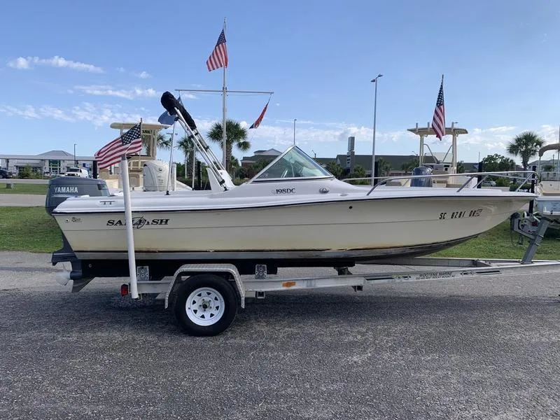 Slide: The Image of 2005 Sailfish 198 DC boat on trailer with Yamaha motor, parked outdoors. - 5