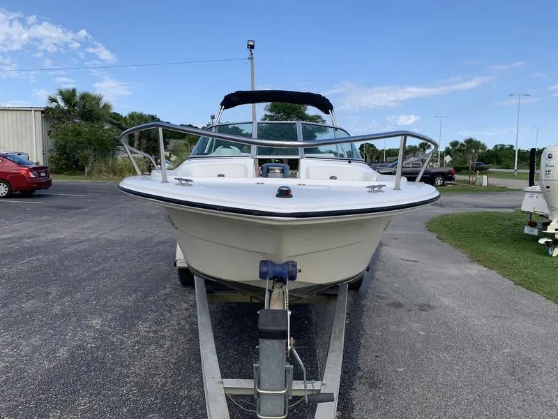 Slide: The Image of 2005 Sailfish 198 DC boat on trailer, parked outdoors on a sunny day. - 7