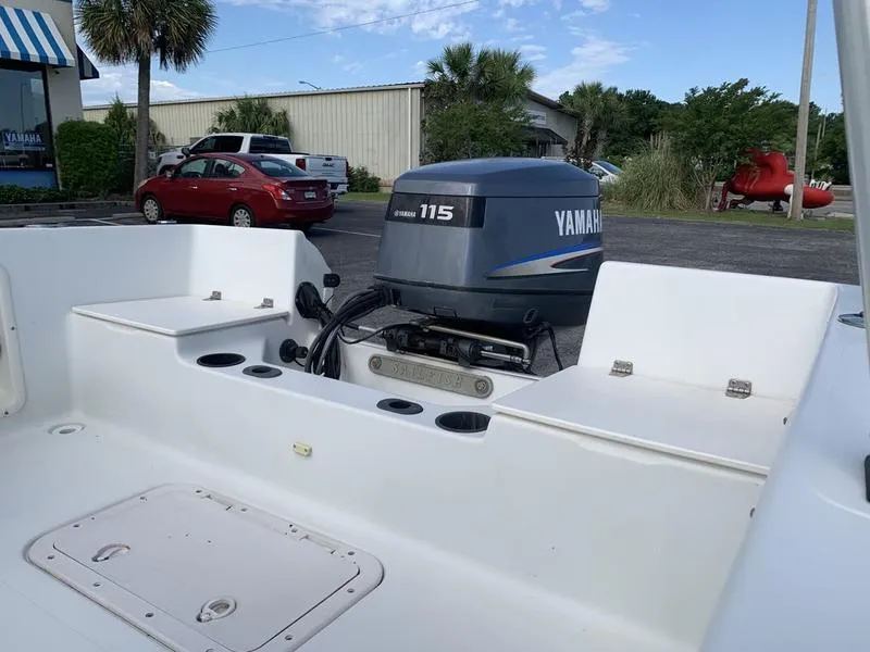 Slide: The Image of 2005 Sailfish 198 DC boat with Yamaha 115 outboard motor in a parking lot. - 9